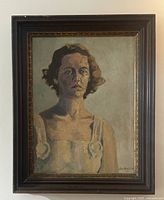 Frontal view of framed oil on board portrait depicting a young woman, full frame visible.