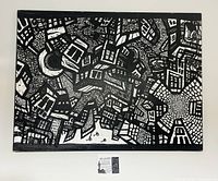 Full front view of black and white canvas painting hung on wall