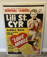 Full view of vintage movie poster "Love Moods" featuring Lili St Cyr with color illustrations and text.