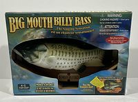 Front view of the Big Mouth Billy Bass in original box showing the fish mounted on plaque and branding on box.