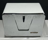 Front view of vintage GSW breadbox showing chrome door with black handle and brand nameplate.