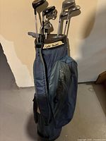 Photo of the entire golf set in the standing bag, showing multiple clubs and the bag labeled 'Left Handed'.