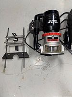 Top view of Craftsman Super Router plunge router with guide attachment on floor showing condition and components