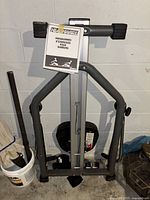 Rowing machine frame with manual taped to it, showing physical condition and structural design