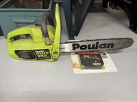 Photo showing Poulan Micro XXV chainsaw with attached guide bar and chain, placed on floor near a metal storage cabinet.