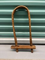 Full view of the antique wooden butter churn, showing its shape and handle.