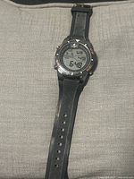 Full view of Caribbean Joe digital wristwatch showing face and black textured rubber band with stainless steel buckle.