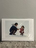 Sealed art card featuring winter scene of two figures in parkas on snow