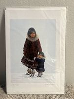 Photo of Dorothy Francis art card 'Little Sister' showing full artwork of two Indigenous girls in traditional winter clothing on snow.