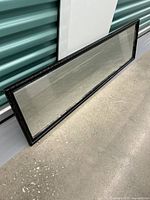 Full view of the full-length mirror lying flat showing the entire glass and frame.