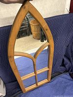 Front view of the gothic style pointed arch window mirror showing the pine wood frame and divided glass panes.