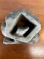 Top view showing the hollow geometric center and overall shape of the soapstone carving.
