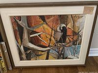 Front view of abstract forest painting, showing framed artwork with earthy abstract design