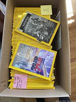 Box filled with National Geographic magazines, two visible on top with cover photos and title dates July 1971 and July 2011