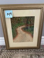 Frontal view of framed watercolor painting 'Into the Forest' by Lynn Malenfant, showing forest path scene.