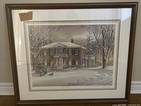 Full view of the framed print showing the winter house scene and wooden frame