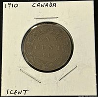 Reverse side of 1910 Canadian large one cent coin showing ONE CENT text, date 1910 and maple leaf border, in card holder.