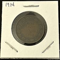Reverse of 1914 Canadian one cent coin showing denomination, country, and year with wreath design.
