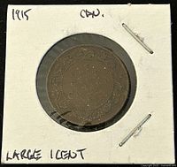 Front view of the 1915 Canadian Large One Cent coin showing the denomination and ornate detailing on the reverse side.