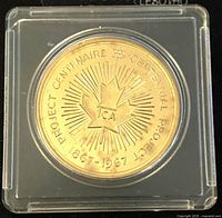 Front side of 1967 Canadian Centennial Project coin with maple leaf, TCA logo, and dates 1867-1967