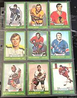 Nine 1973-74 O-Pee-Chee hockey trading cards with green borders displayed on a black background. Front side with player images and stats visible on the back for one card.