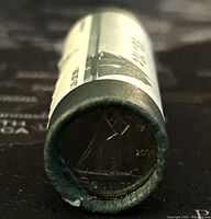 End view of 2005 Canadian dime coin with sailboat design visible on the edge of the roll.