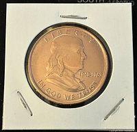 Obverse side of 1 oz copper bullion round showing Benjamin Franklin profile, LIBERTY, and IN GOD WE TRUST inscriptions, dated 1706-1790.