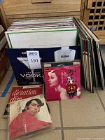 Photo showing a batch of vinyl records stored upright in a box, some with Japanese text and images, some classical music albums visible.