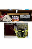 Photo of boxed camping and picnic supplies including disposable cups, fuel cans, and two portable gas stoves.