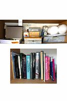 Photo showing vintage Boston paper cutter, label maker, wood storage trays, some bubble wrap and packing tape, and several books of varying topics.