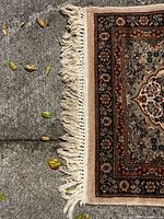 Close-up photo of the fringed edge of the runner showing spots and discoloration on the fringe.