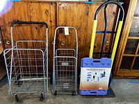 Front view of hand truck, two collapsible metal wire carts, and the heavy duty dolly.