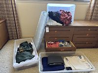 Multiple bins and drawers filled with assorted Japanese robes in various colors and fabrics.