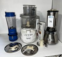 Cuisinart food processor with bowl and slicing/shredding attachments, Hamilton Beach blue blender, Waring commercial blender shown with food processor and manual.