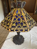 Tiffany style stained glass lamp showing front and decorative glass colors and patterns.
