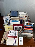 Large assortment of boxed stationery, individual greeting cards organized in stacks, various postal cards, and envelopes in different colors and sizes.