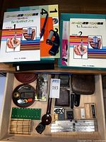 Full display of vintage Japanese calligraphy practice books, stamps, tools, and accessories.