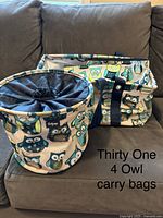 Four owl print carry bags made by Thirty One, displayed on a couch, depicting the owl design and bag types.
