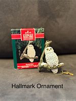 Photo shows Hallmark Keepsake ornament of a snowy owl perched on a branch with original packaging box behind it.