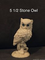 Front view of 5.5 inch carved stone owl figurine with detailed feathers and blue eyes.