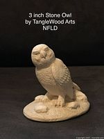 Single photo showing one 3 inch carved stone owl figurine by Tanglewood Arts NFLD on a black background to highlight texture and details.