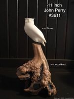 Photo of 11 inch white stone owl sculpture by John Perry perched on wood knot base, labeled with size and artist name.