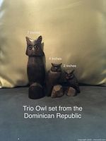 Photo of three solid wood owl figurines in a trio set from the Dominican Republic, sizes indicated as 7, 4, and 2 inches.