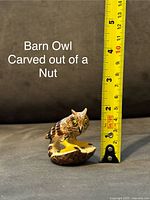 Single barn owl figurine carved from a nut with a measuring tape showing approx 4.5 cm height