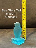 Blue glass owl figurine made in Germany, shown next to ruler for size reference, approximately 3.5 inches tall
