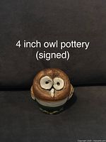 Single 4-inch owl pottery figurine, brown and cream with expressive eyes, glossy finish.