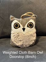 Front-facing photo of 8-inch weighted cloth barn owl doorstop on a gray background, showing detailed embroidery and texture of the fabric.