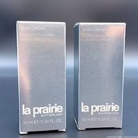 Two silver packaging boxes of La Prairie Skin Caviar Essence-in-Lotion, each labeled 10ml/0.34 fl oz.