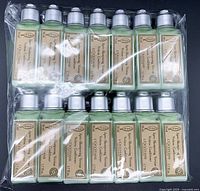 Front view of 14 bottles of L'Occitane verbena hair conditioner in original packaging, showing the label and green product inside transparent bottles.