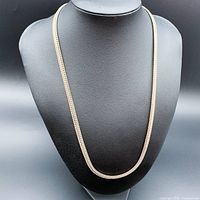 Front view of 23 inch 925 sterling silver chain necklace displayed on a black stand.